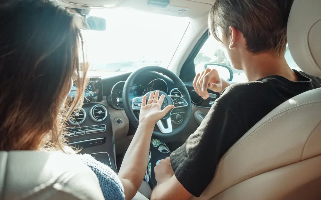Driving instructor in the passenger seat beside a learner driver